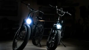 two ebikes in a dark garage with lights on